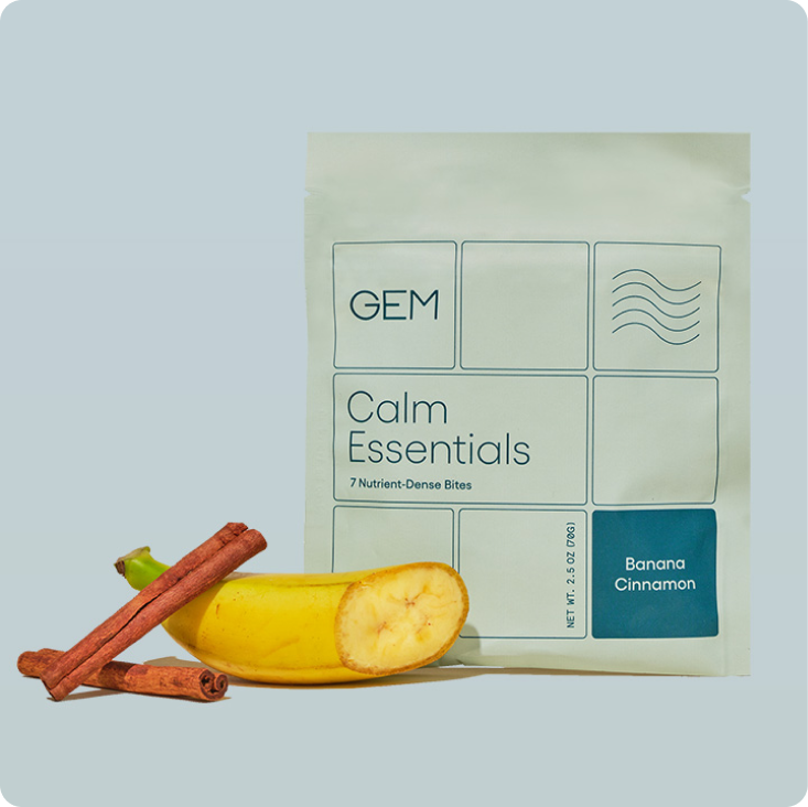 One 7 Bite pack of GEM Banana Cinnamon Calm Essentials nutrient-dense real-food Bites featuring half of a banana and a stick of cinnamon.